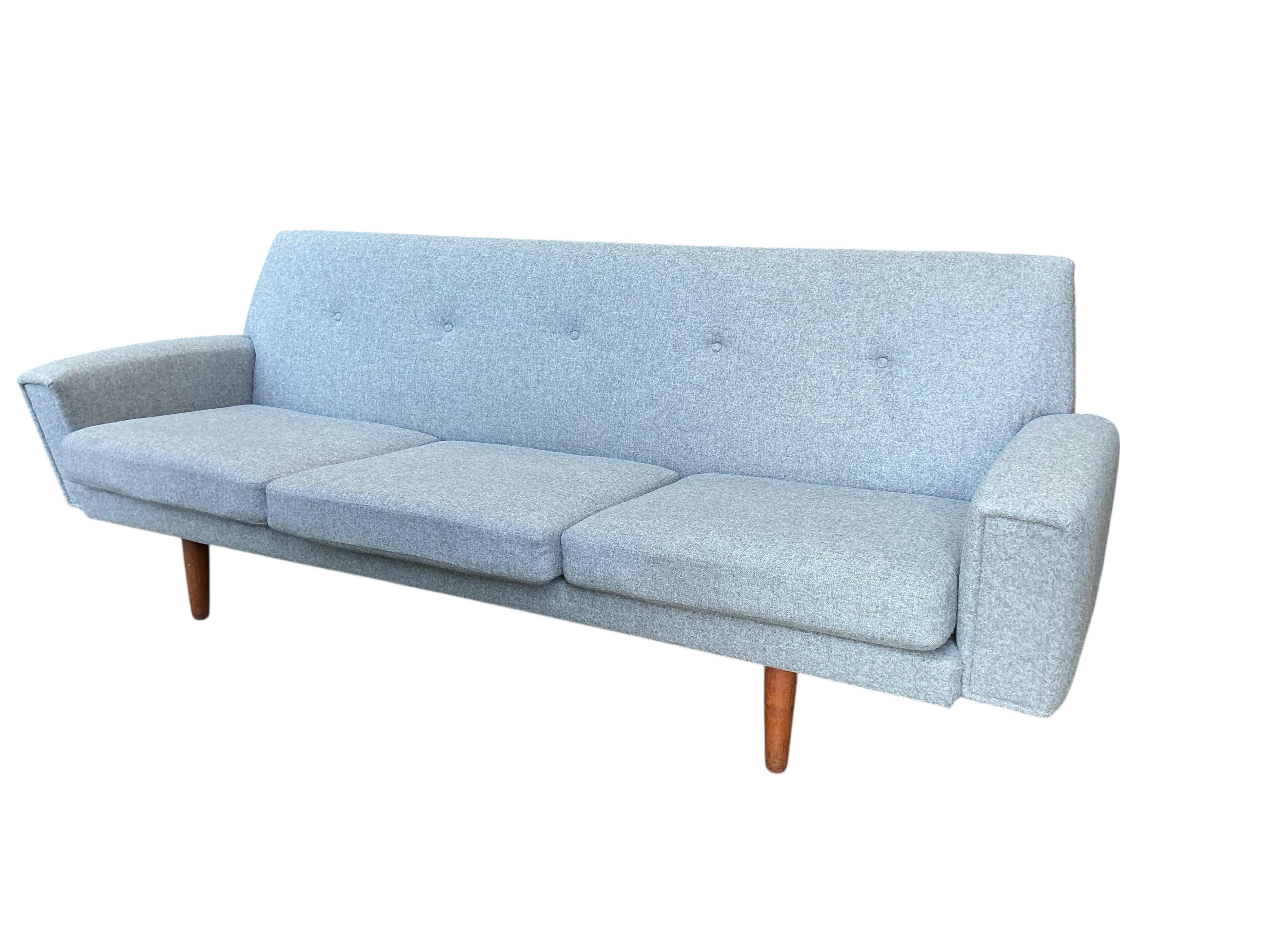 In the manner of Georg Thams, a Danish style mid century design three seater settee upholstered in grey wool fabric, width 214cm, depth 68cm, height 73cm